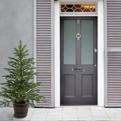 National Tree Company Slim^Artificial Entrance Christmas Tree, Norwegian Spruce, Green, White Lights, Includes Barrel Base, 4 Feet